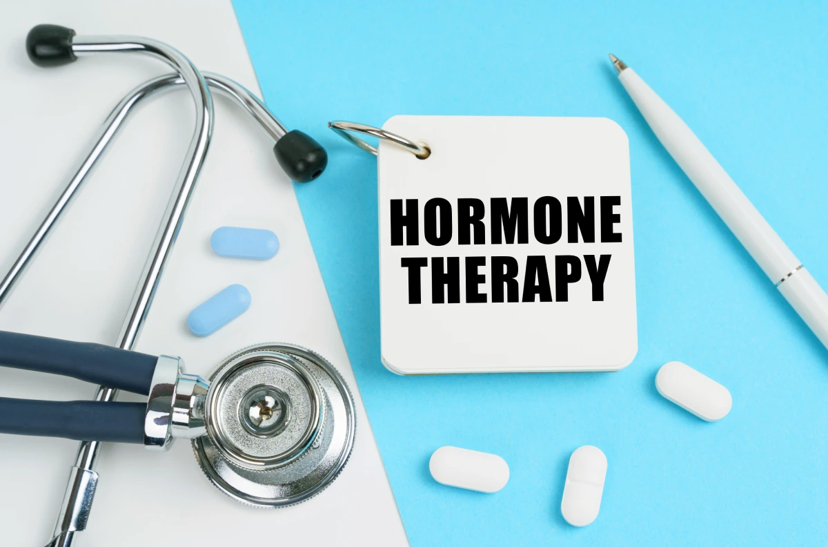 Stethoscope and pills illustrating hormone therapy concept.