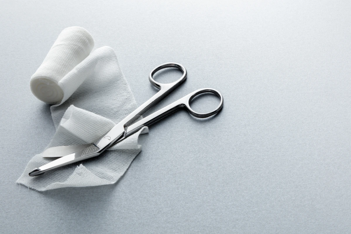 Surgical scissors resting on a sterile cloth.