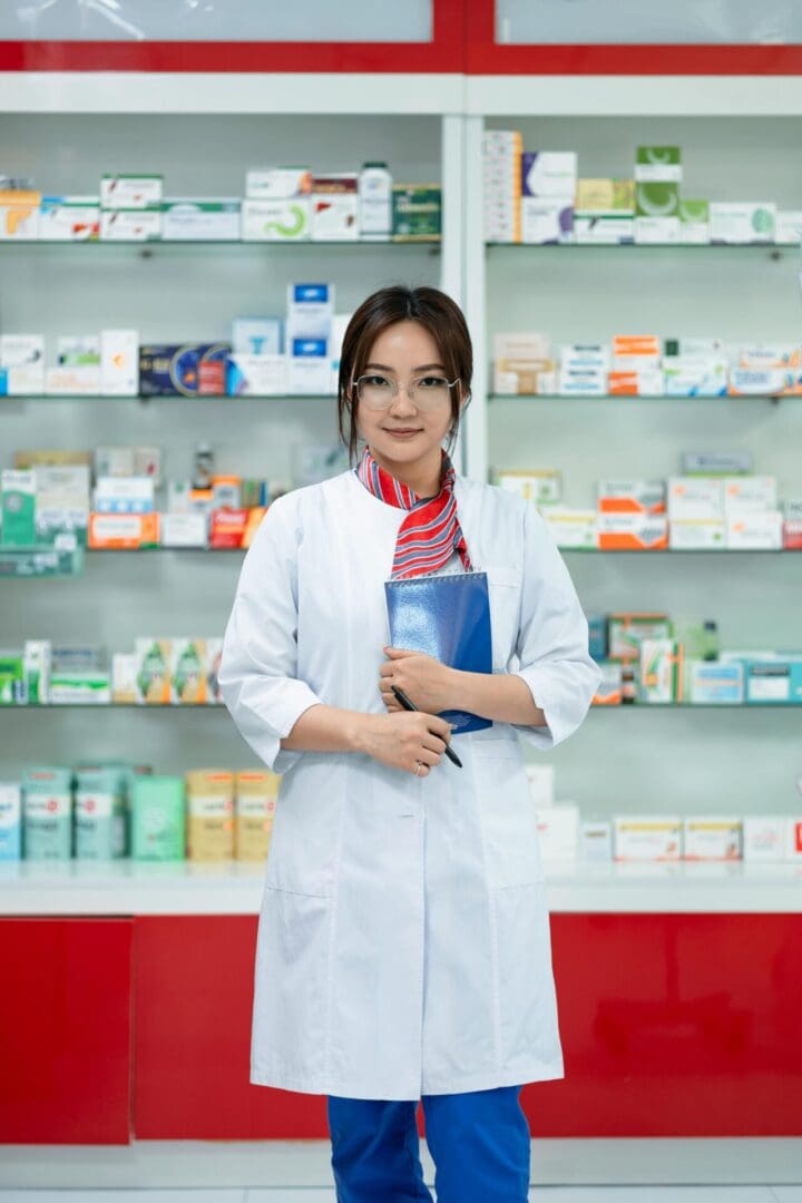 Pharmacist standing confidently in a drugstore with medication shelves behind.