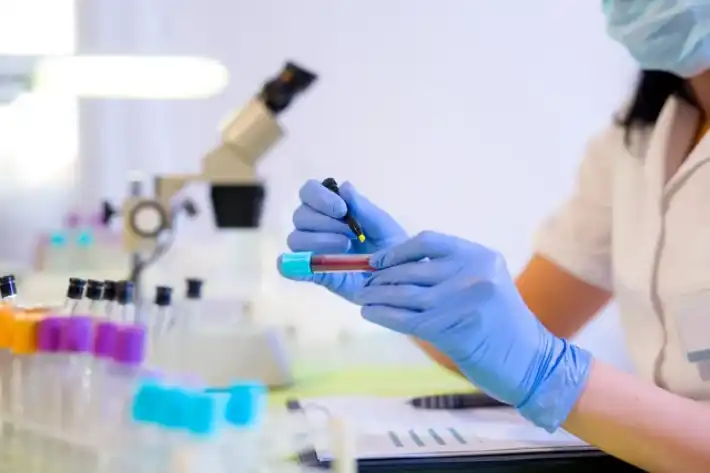 Scientist holding a test tube in a laboratory.
